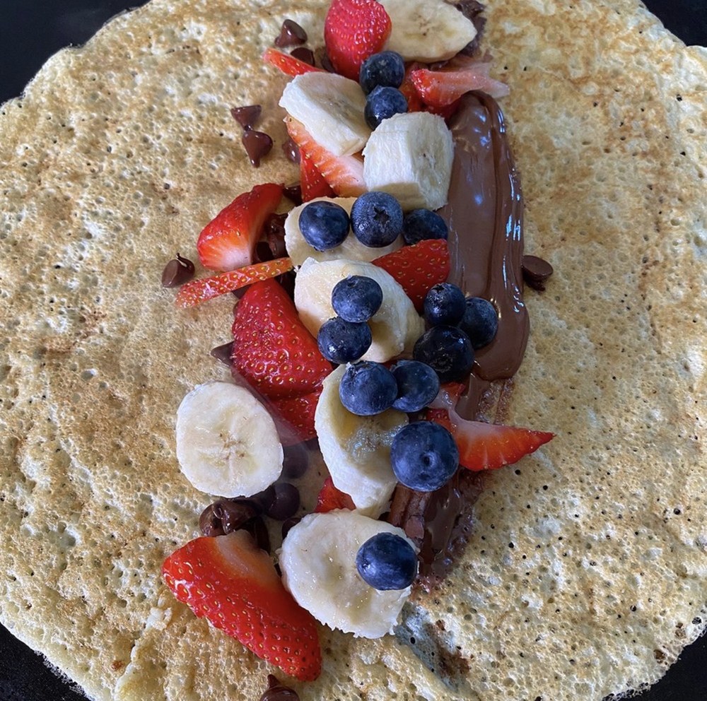 A fully loaded Olivier's crêpe with Nutella, banana, strawberry, and blueberry